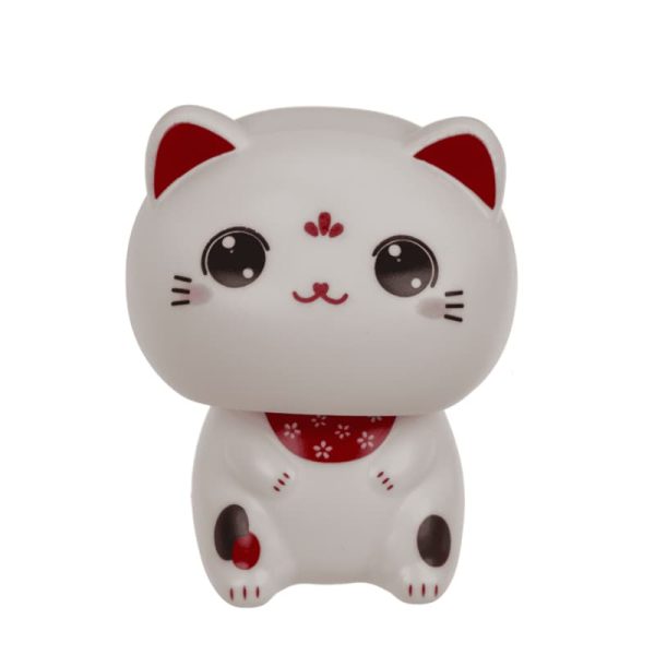 Бяло соларно коте с клатеща се глава